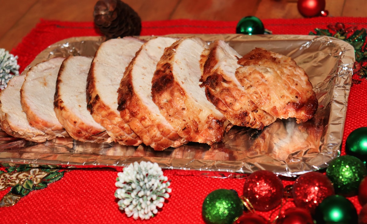 Sliced roasted turkey breast on a platter with christmas decorations